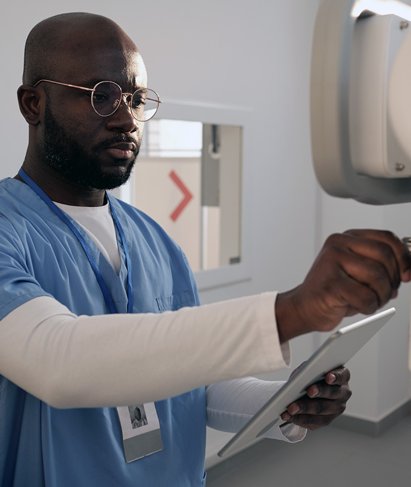 radiologist adjusting medical equipment